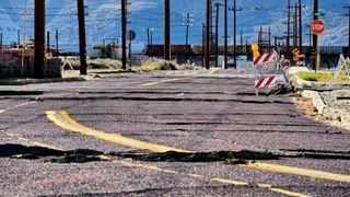 A photo showing a road torn up by an earthquake