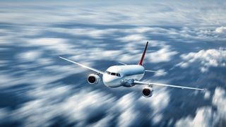 A commercial airliner soaring through the clouds. 